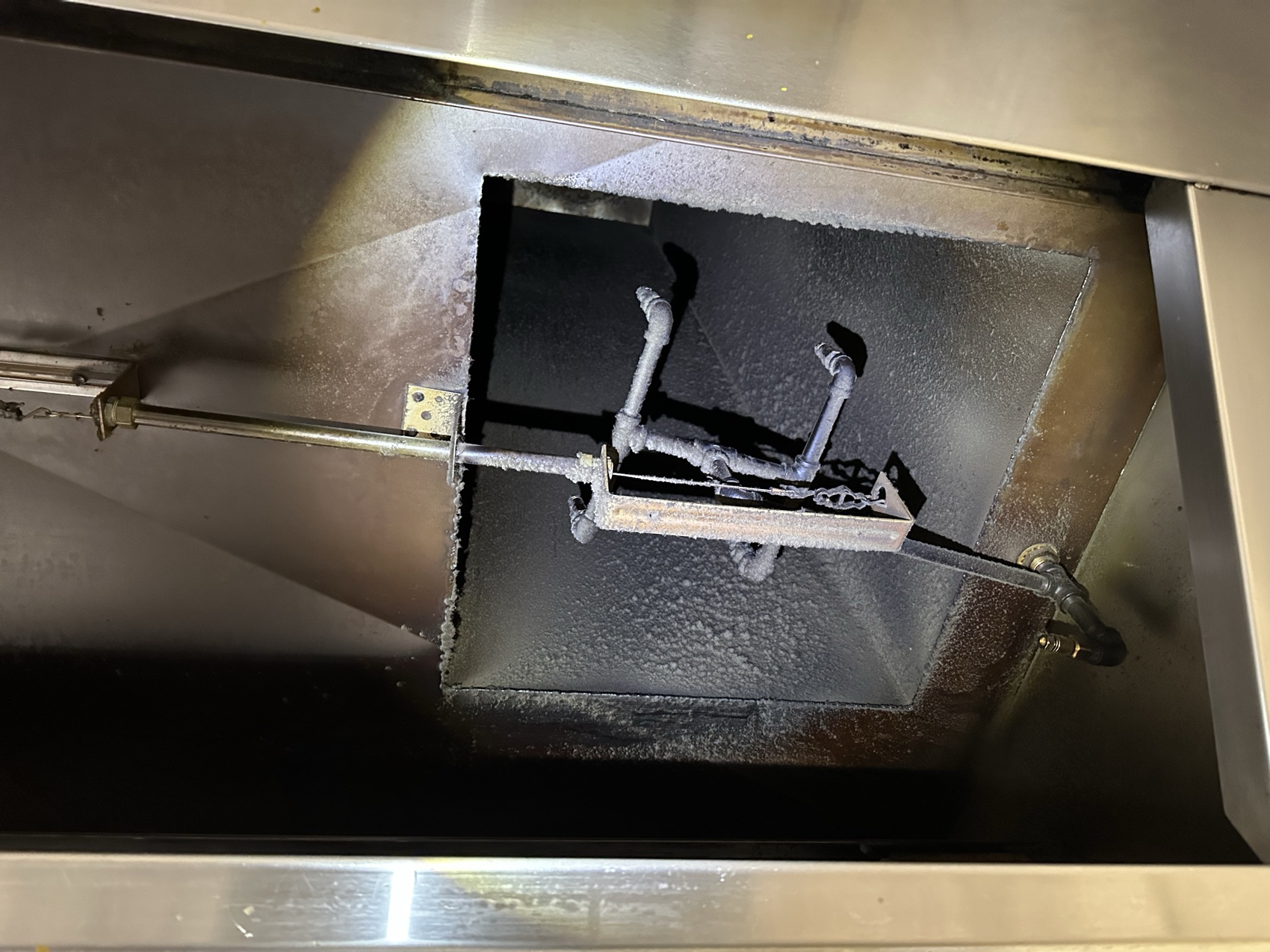 Grease-blackened hood interior before cleaning