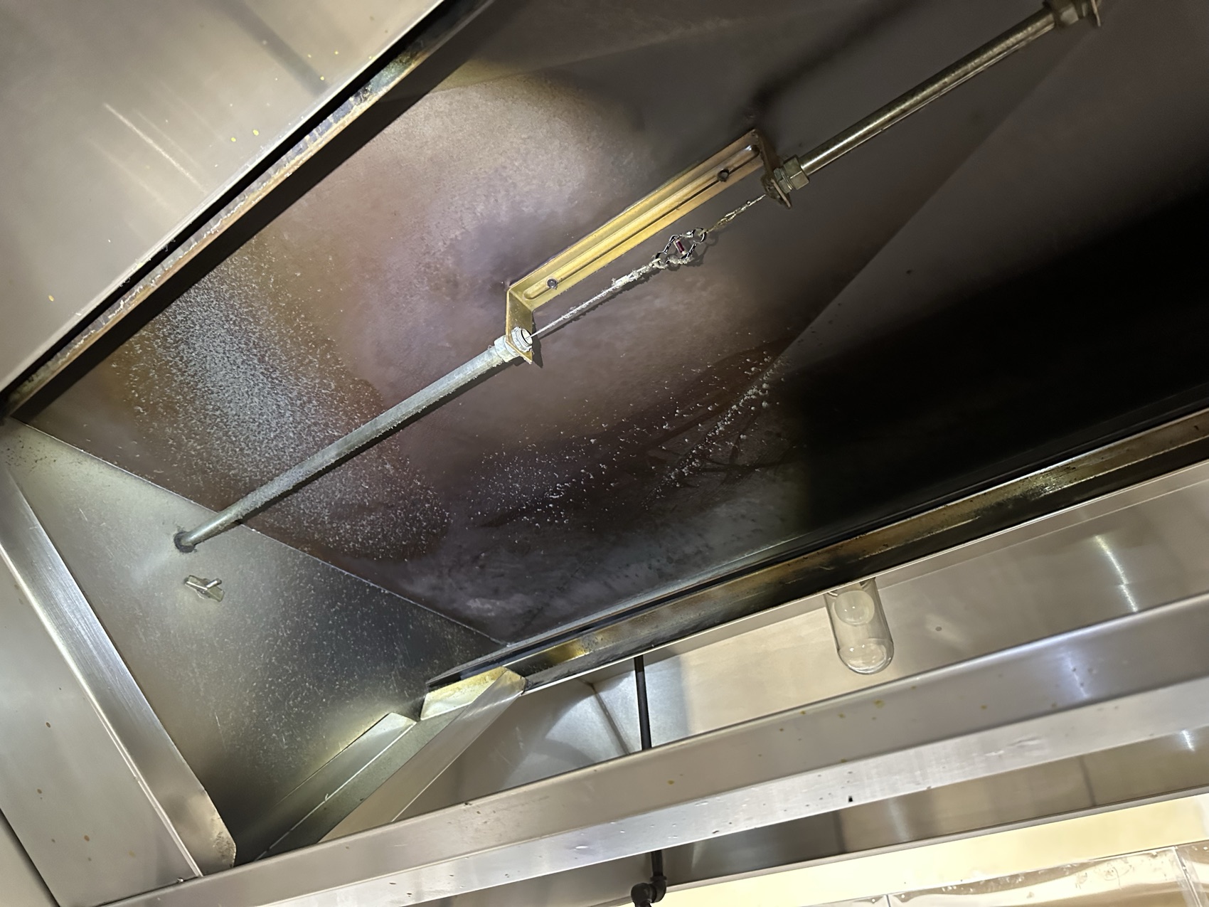 Grease-stained hood plenum before cleaning