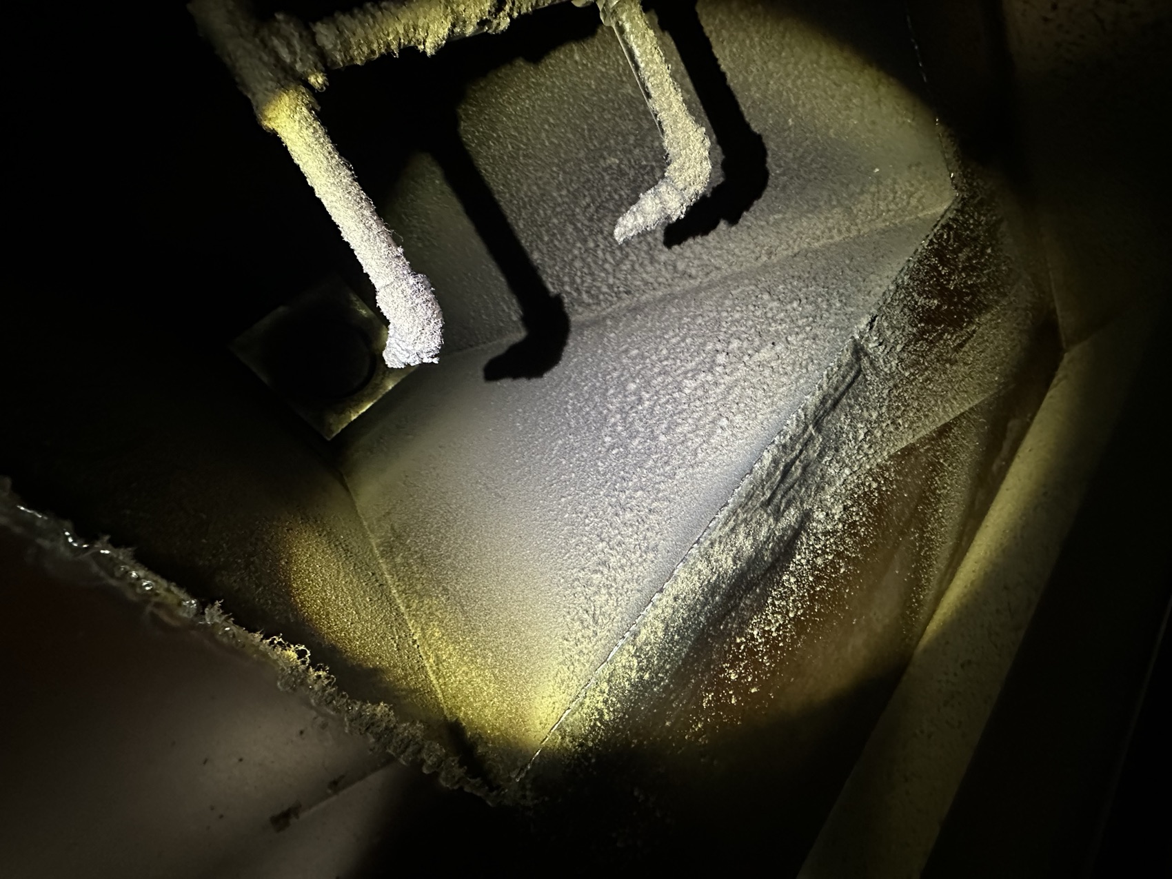Grease-caked exhaust duct before cleaning